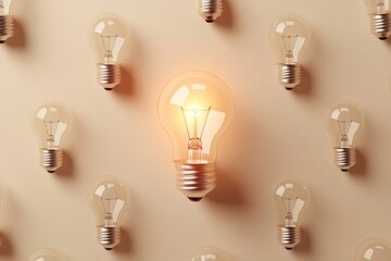 One lit light bulb among a group of unlit light bulbs on a beige background.