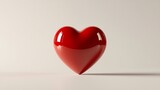 A shiny red heart-shaped object on a light background symbolizing love and affection, perfect for Valentine's Day themes and romantic designs.