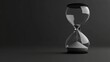 © ZeeZaa - A glass hourglass with sand in it is sitting on a dark background
