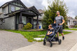 © edb3_16 - Father Enjoying a Stroll with Toddler in Stroller Through Residential Neighborhood in Mission, BC, Canada