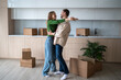 © DimaBerlin - Overjoyed wife and husband hugging on kitchen moving to new flat among cardboard boxes. Relocation, family mortgage, buying apartment, real estate. Happy emotional couple spouses enjoying life changes