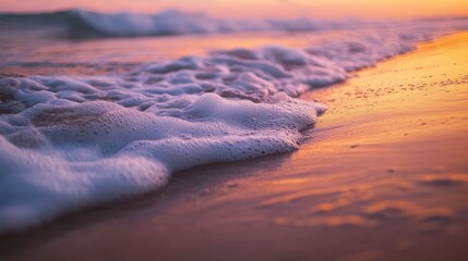 Soft waves gently lapping against a sandy shore at dawn, creating a calm, serene mood.