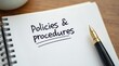 © vitanovski - Policies and procedures memo with fountain pen on notebook