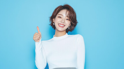 A cheerful Korean woman in a white shirt and grey skirt poses with a thumbsup, showcasing confidence and style.