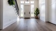 © Sanwa - Modern farmhouse foyer with gray LVP flooring, white walls, black staircase, and natural light.