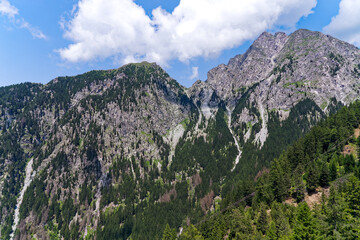 looking up mountain peaks with rocks and cliffs at mountain resort of meran merano 2000 on a summer 