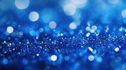 Sapphire glitter bokeh background. Unfocused shimmer royal blue sparkle. Crystal droplets wallpaper