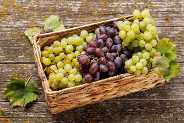 Wall Mural - A wicker basket brimming with a variety of grapes