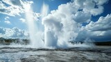 The geyser erupts forcefully, sending streams of water and steam high into the blue sky