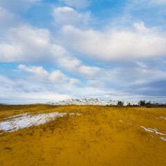 sandy desert under a dense cloudy sky