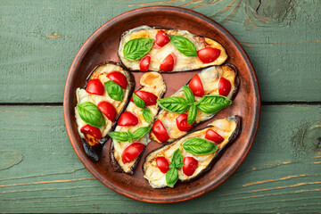 Canvas Print - Italian mini pizza . Aubergine (eggplant ) with mozzarella cheese and basil . On rustic background