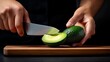 © KN Studio - Avocado Slicing: A close-up shot of a chef's hand meticulously slicing a ripe avocado on a wooden cutting board, showcasing the vibrant green flesh and the sharpness of the knife.