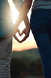 © BestCam/peopleimages.com - Support, heart hands and closeup with couple in nature for love, bonding and honeymoon vacation. Relax, care and adventure with people and emoji sign on date for holiday, sunset and romance together