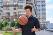 © Valerii Honcharuk - Young male with backpack basketball ball walking outdoors, modern city