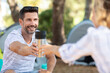 © auremar - camping couple passing a drink