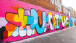 © Dadee - Vibrant street art mural featuring colorful graffiti on a brick wall, showcasing artistic expression and urban culture.