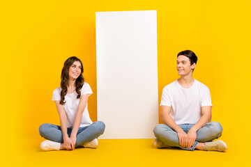 Canvas Print - Full length photo of excited dreamy husband wife dressed white t-shirts reading device empty space isolated yellow color background