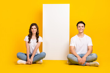 Sticker - Full length photo of cute charming couple wear white t-shirts texting modern gadget empty space isolated yellow color background