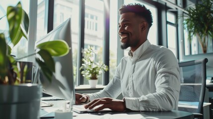 Fototapete - A man is sitting at a desk with a computer monitor