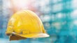 © red_orange_stock - A worn yellow hard hat is prominently displayed at a construction site, showcasing tools and activity in the background under sunlight