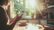 © Sergey - A person sitting at a kitchen table with morning sunlight streaming in, holding a phone.