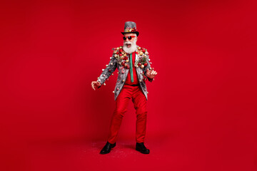 Wall Mural - Full size photo of happy cheerful old man dancing good mood wear christmas tree balls costume sunglasses isolated red color background