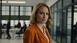 © Alteisen Riese - twenties caucasian woman in orange attire on office background model portrait looking confident for ad concept space for text