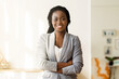 © Prostock-studio - Business Career. Portrait Of Successful African American Businesswoman Posing With Arms Crossed At Workplace In Modern Office, Free Space