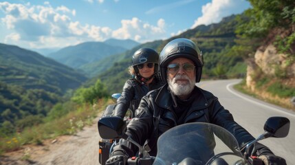 A man and woman are riding a motorcycle on a mountain road