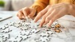 © night - A woman's hands working on a large jigsaw puzzle.