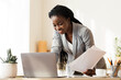 © Prostock-studio - Successful Project. Smiling Afro Business Lady Working With Papers And Laptop In Modern Office, Free Space