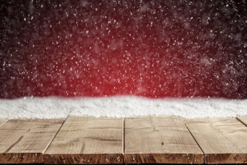 Canvas Print - Wooden table with empty copy space and red christmas background with snowflakes