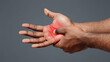 © Prostock-studio - Pain in palm. Male hand suffering from work, afro man massaging sore zone, close up
