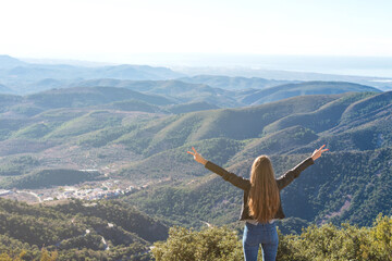 Beautiful women showing peace sign while enjoying mountains landscape