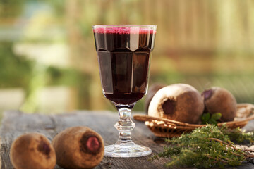 Wall Mural - Red beet juice in a glass, with fresh beetroot