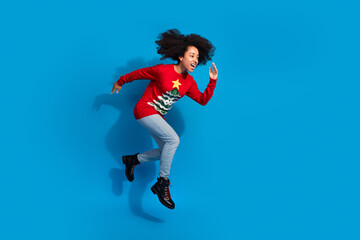 Poster - Photo of cheerful optimistic woman wear red stylish clothes run fast empty space xmas new year isolated on blue color background