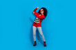 © deagreez - Full body photo of attractive young woman sunglass dancing dressed red christmas clothes theme party on blue color background