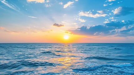 A breathtakingly beautiful sunset seaside scenery. The sky is ablaze with warm hues of orange, pink, and purple as the sun dips below the horizon. The waves gently lap at the shore, creating a soothin