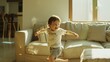 © VK Studio - A cheerful, young boy joyfully runs in a sunlit, cozy living room, capturing the essence of childhood happiness and freedom.