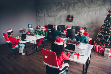 Wall Mural - Portrait of group friends colleagues working desktop laptop computer christmas party loft office indoors