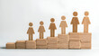 © natalystudio - Abstract business growth concept, figures on wooden steps on white background career advancement, leadership and support visual