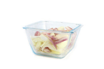 raw, chopped onion and shallots in a transparent bowl, isolated on a white background 