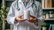 © Nurul - Healthcare Professional Holding Prescription Bottle with Focus on Medicine