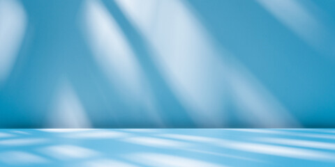 panoramic abstract blue background for product presentation with sunlight and blurred shadows wall. 