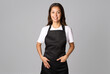 © Gecko Studio - Friendly waitress, female barista in black apron. Young woman wearing black apron and white shirt standing on a white background with copy space
