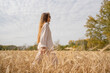 © Николай Амосеев - A Stylish Woman is Enjoying a Beautiful Sunny Day in the Middle of a Wheat Field