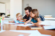 © StarDweller/peopleimages.com - Father, children and paper in home for education, distance learning and creativity for growth. Dad, kids and happy at table for fun activity, art project and drawing skill development in lesson