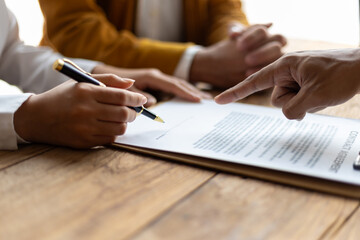 Legally signing a real estate agreement. Businessman negotiates with house sales agent before signing contract.