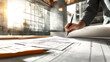 © Akash - background with an architect working on blueprints in a contemporary design studio