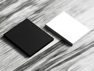 A black and white business card sitting on top of a wooden table